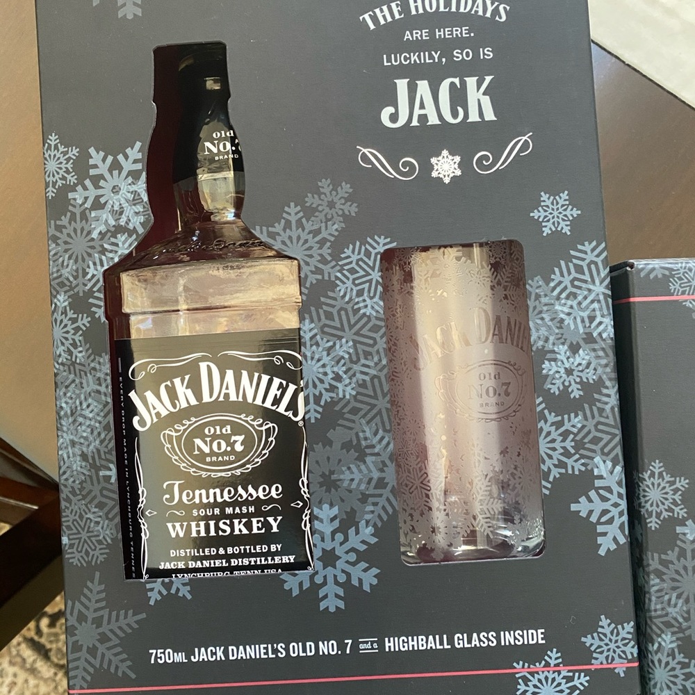 Empty Jack Daniels bottle with glass & box.